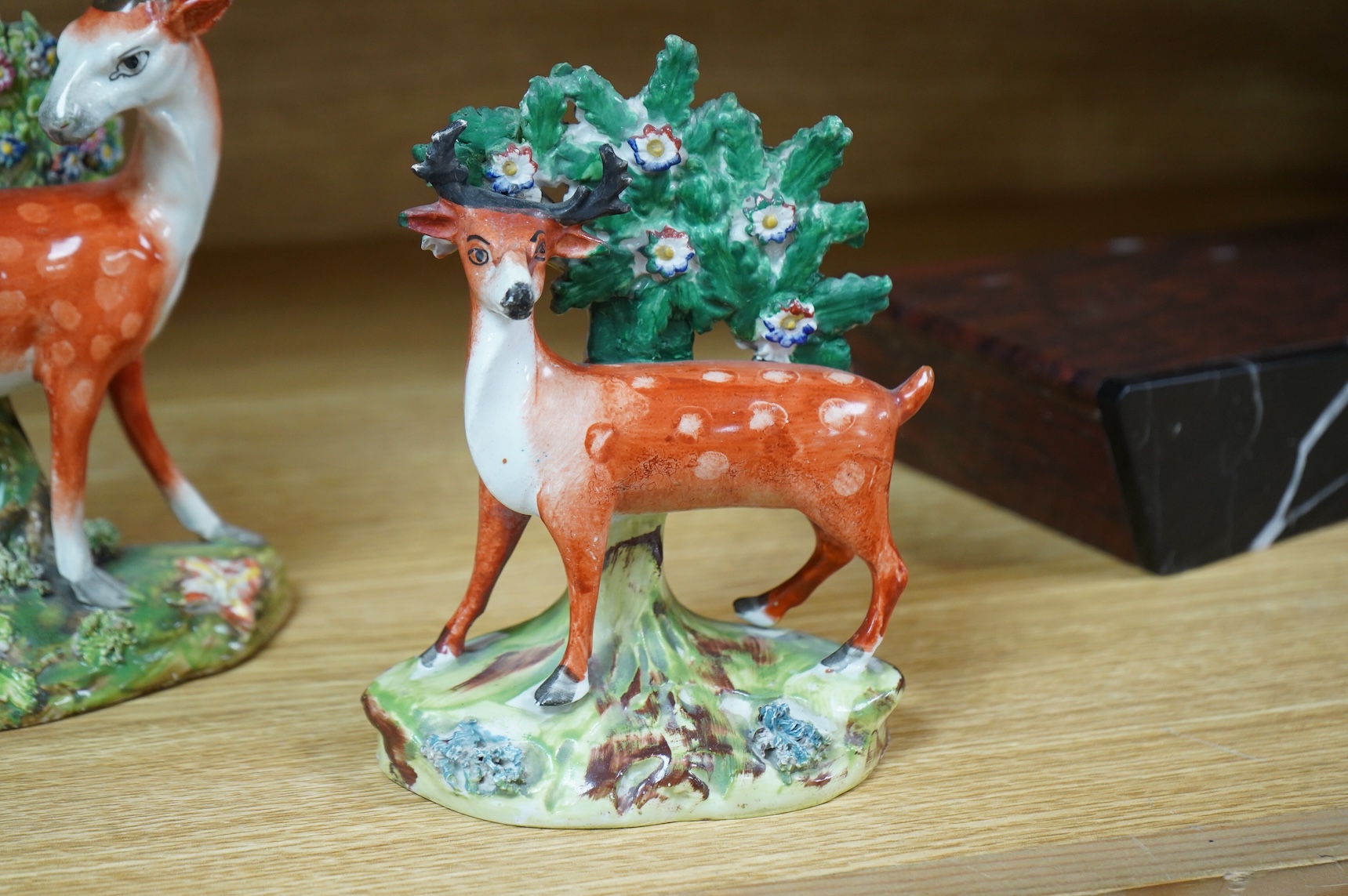 Three early 19th century Staffordshire pottery models of deer, largest 16cm high
